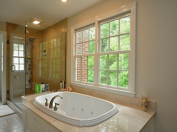 81 Montvale Road Weston, MA 02493 - Photo 21 of 27 a bathroom with a tub a sink and a window