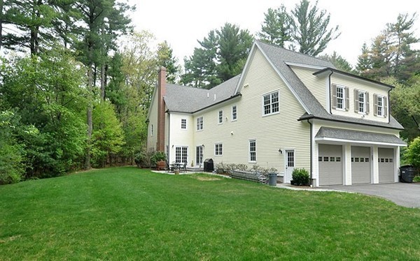 81 Montvale Road Weston, MA 02493 - Photo 27 of 27 a view of a yard in front of a house with plants and large tree