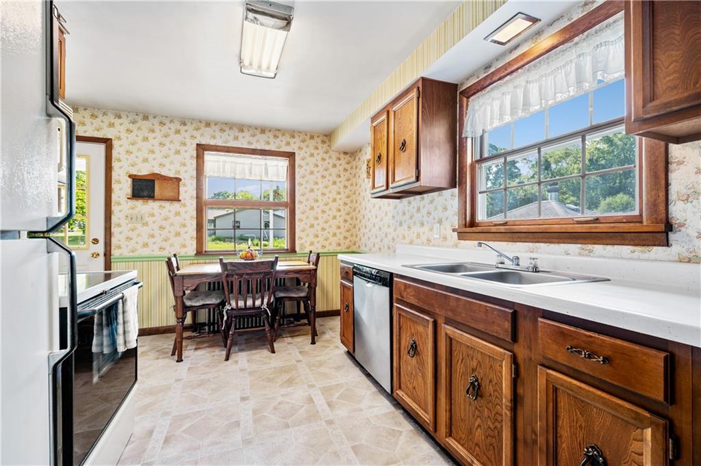 1178 Freeport Road Kittanning, PA 16201 - Photo 11 of 25 a kitchen with stainless steel appliances granite countertop sink stove window and dining table