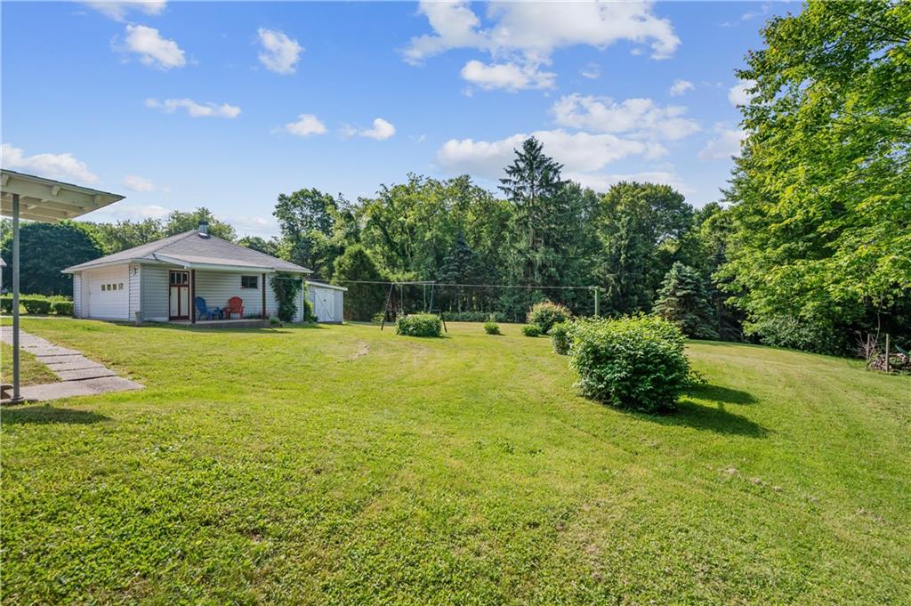 1178 Freeport Road Kittanning, PA 16201 - Photo 24 of 25 a white house with a big yard and large trees
