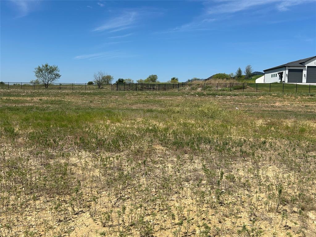 1033 Bear Creek Ranch Road Aledo, TX 76008 - Photo 4 of 9 a view of a big yard with an buildings in the background