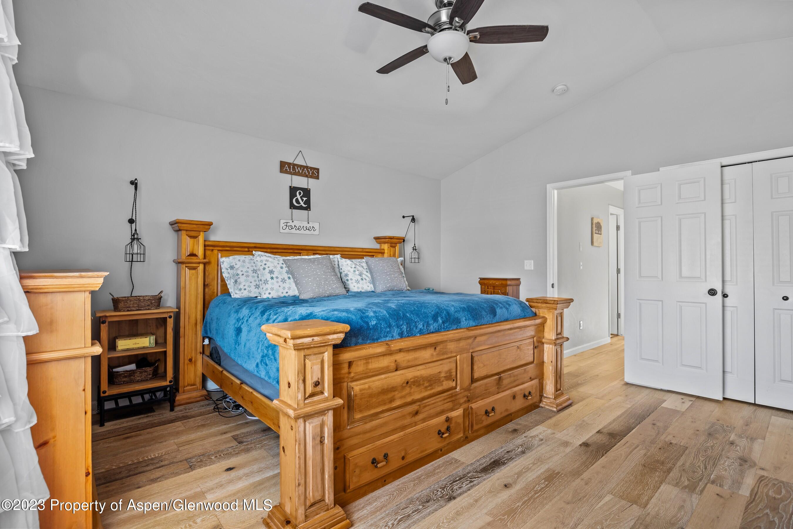 1273 East 18th Way Rifle, CO 81650 - Photo 14 of 26 a bedroom with a bed and wooden floor