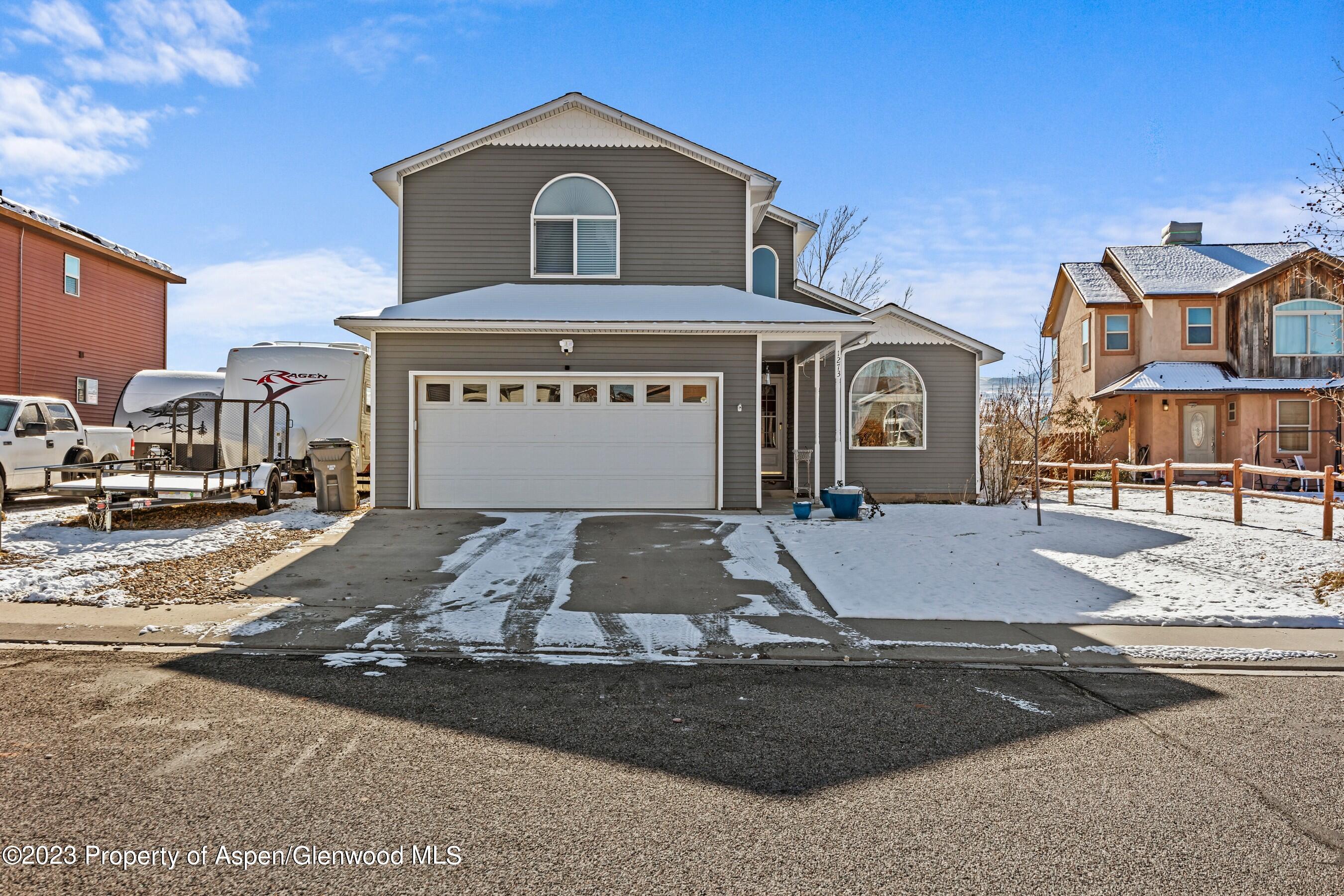 1273 East 18th Way Rifle, CO 81650 - Photo 2 of 26 a front view of a house with yard