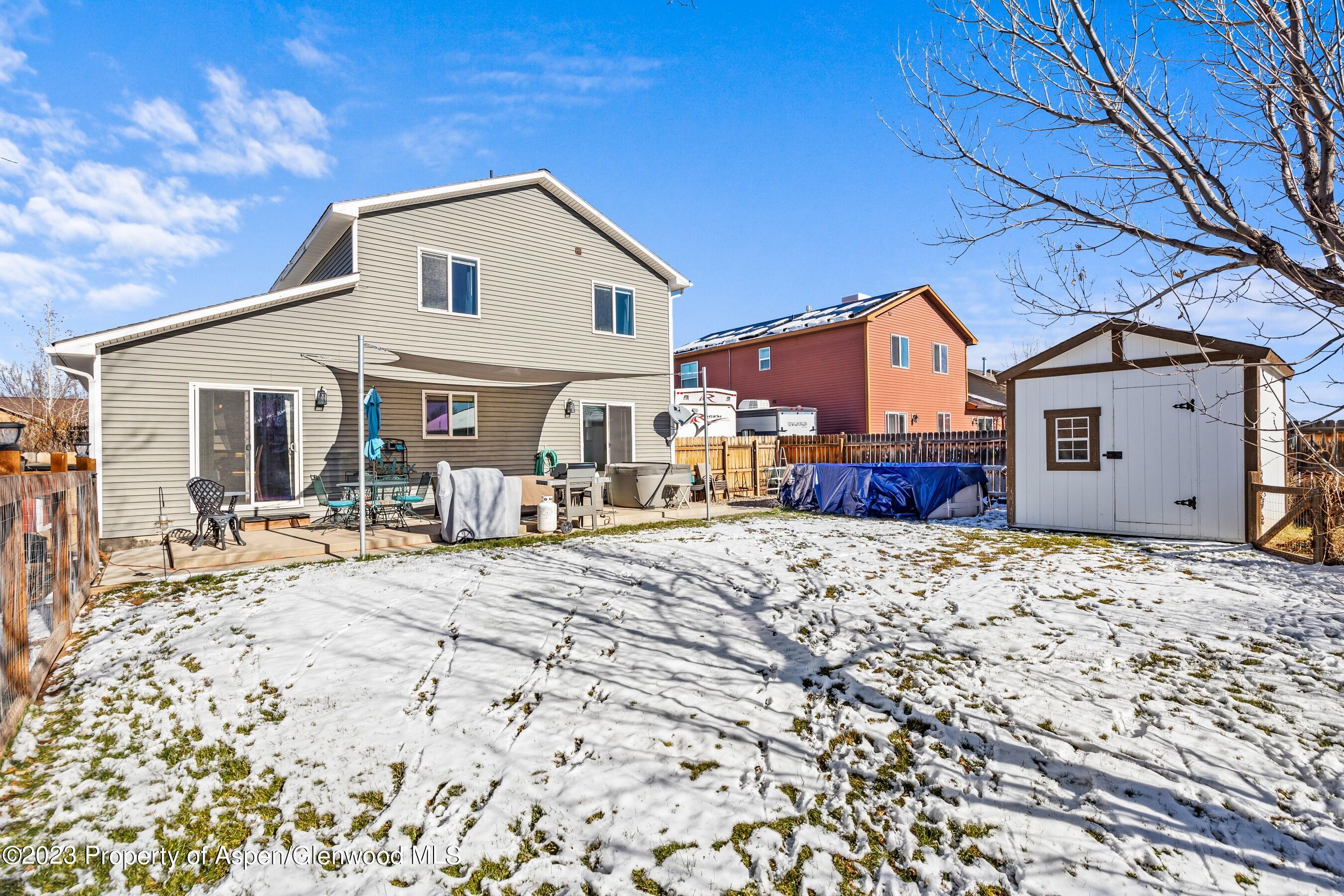 1273 East 18th Way Rifle, CO 81650 - Photo 26 of 26 a front view of a house with a yard covered with snow in front of house