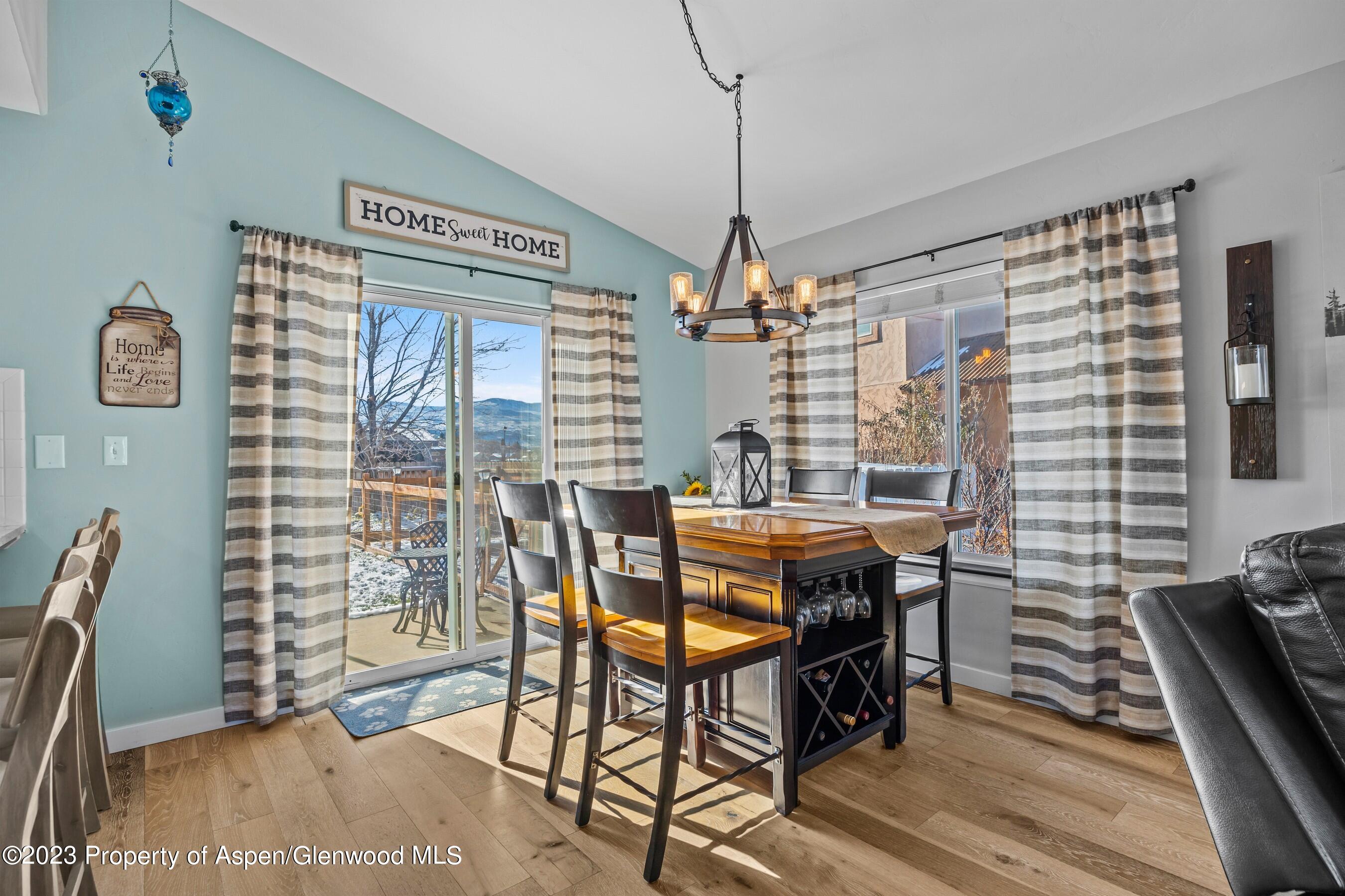 1273 East 18th Way Rifle, CO 81650 - Photo 7 of 26 a view of a dining room with furniture window and wooden floor