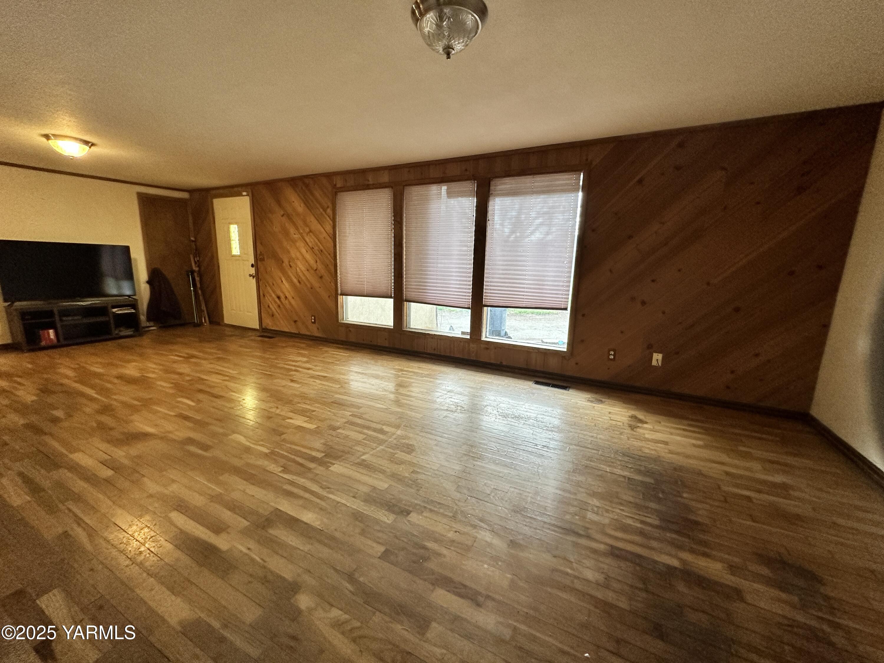 1122 McClain Drive Sunnyside, WA 98944 - Photo 2 of 8 a view of an empty room with a window and a fireplace