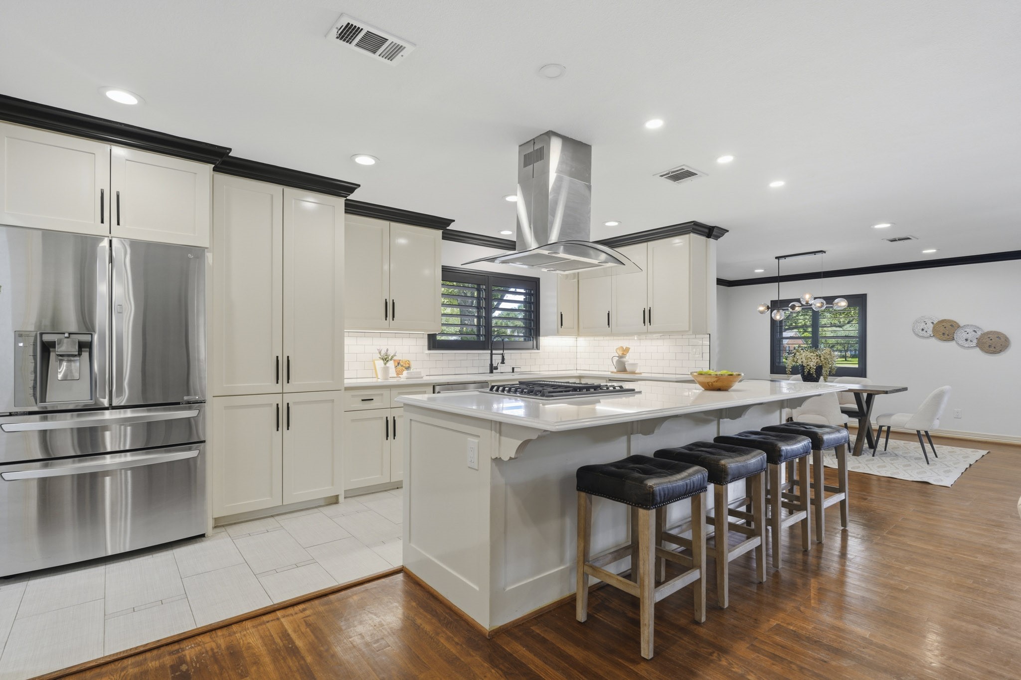 2302 Chimney Rock Road Houston, TX 77056 - Photo 10 of 28 Beautiful timeless designed kitchen with quartz countertops, gas stove top, stainless steel appliances, trash compact system, under-mount cabinet lighting, LED recessed lighting, stately crown molding, and fresh paint throughout.