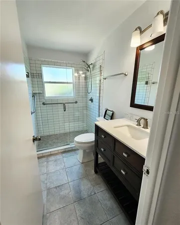 a bathroom with a double vanity sink mirror and toilet