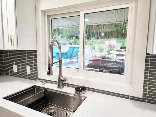 a kitchen with a sink and large window
