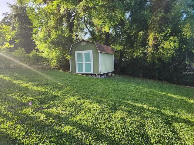 a front view of a house with yard and green space