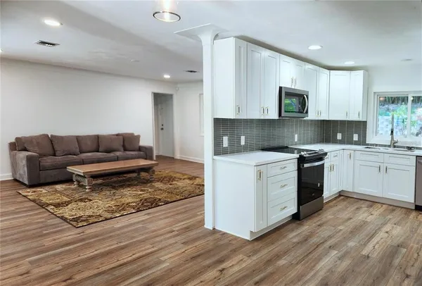 a kitchen with a white cabinets and white appliances