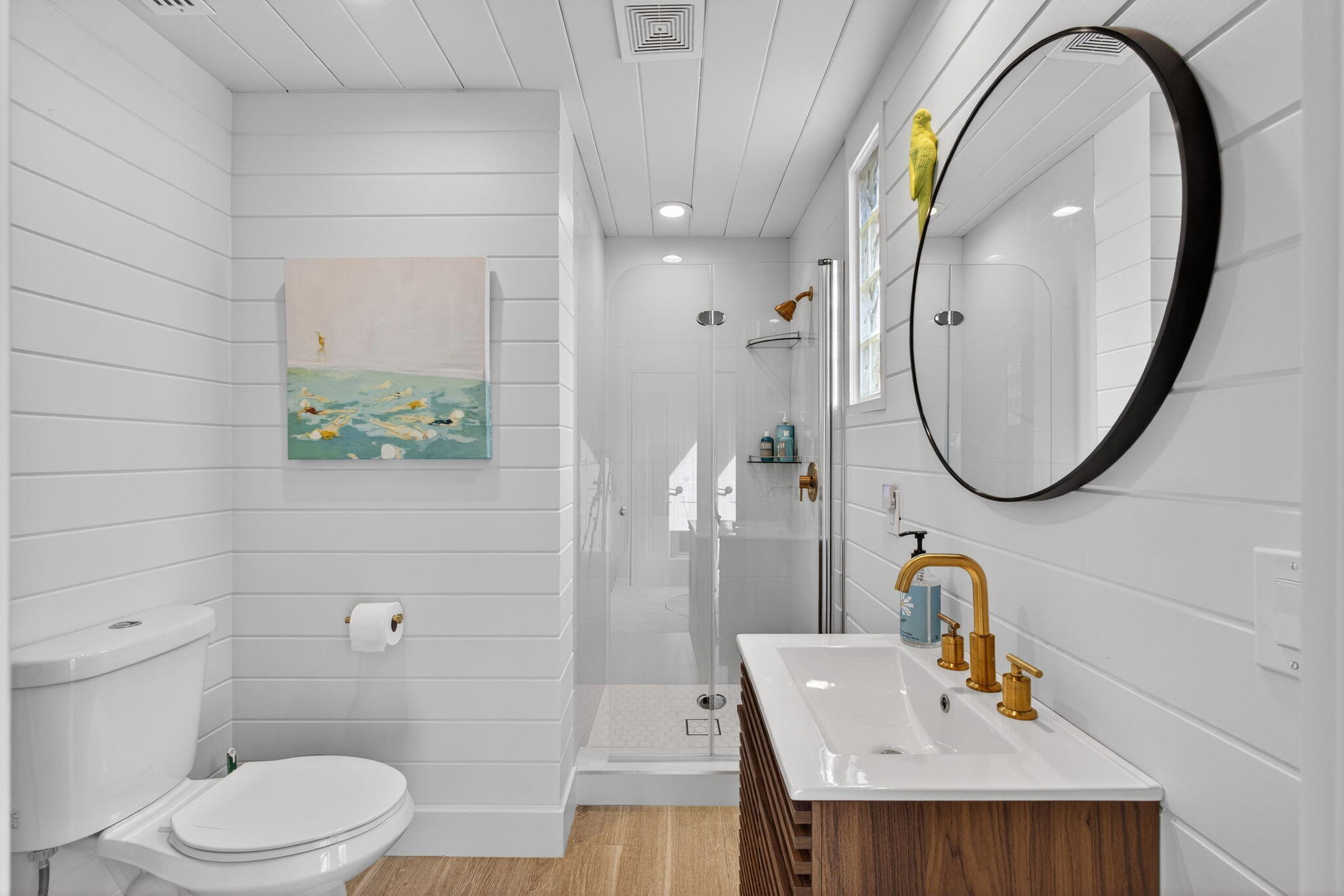 17085 Bay Street Jupiter, FL 33477 - Photo 31 of 44 a bathroom with a sink a toilet and a mirror