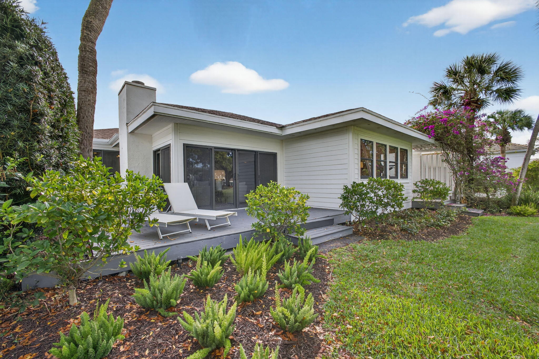 17085 Bay Street Jupiter, FL 33477 - Photo 33 of 44 a view of a house with yard and a garden