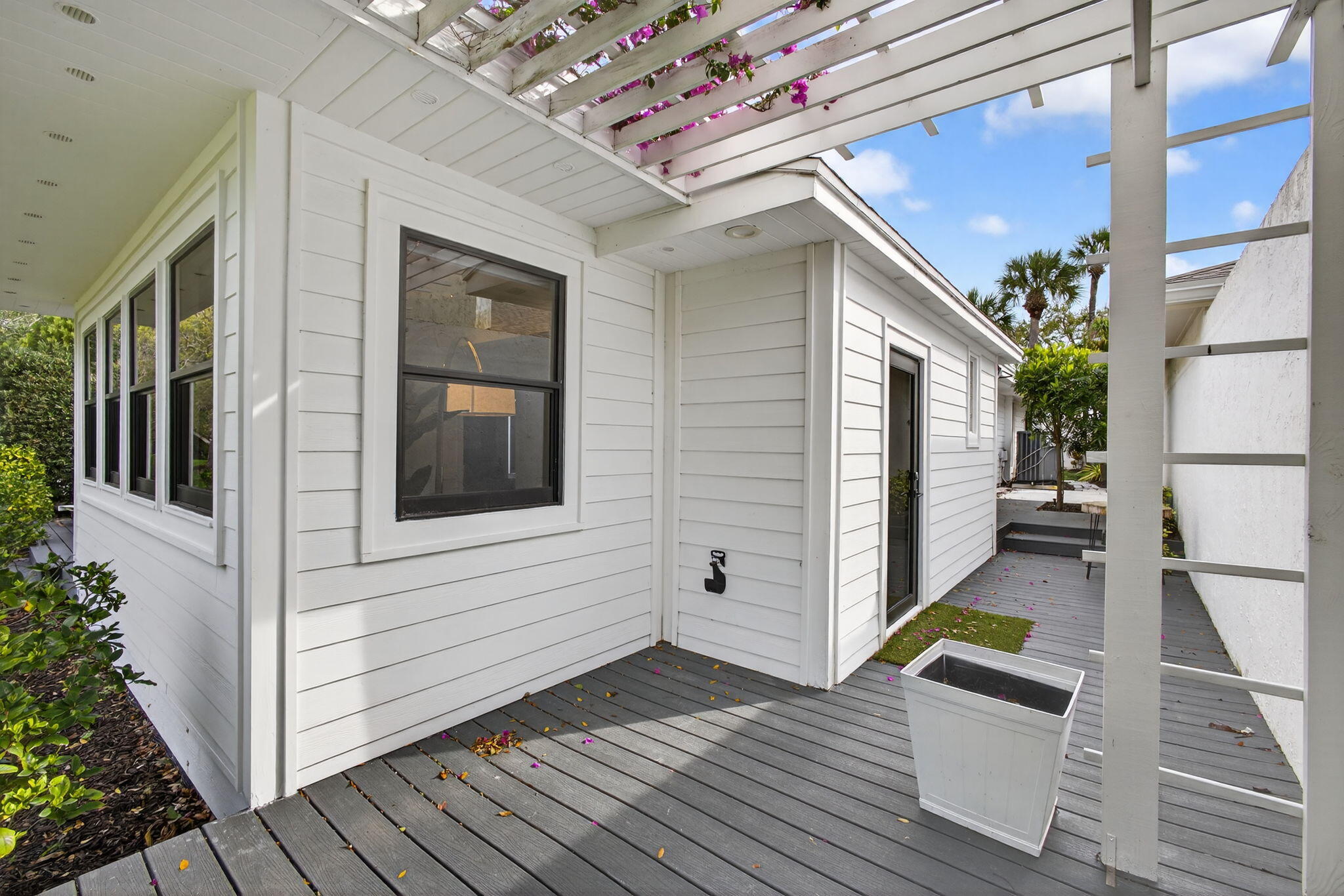 17085 Bay Street Jupiter, FL 33477 - Photo 34 of 44 a view of a house with porch and wooden floor
