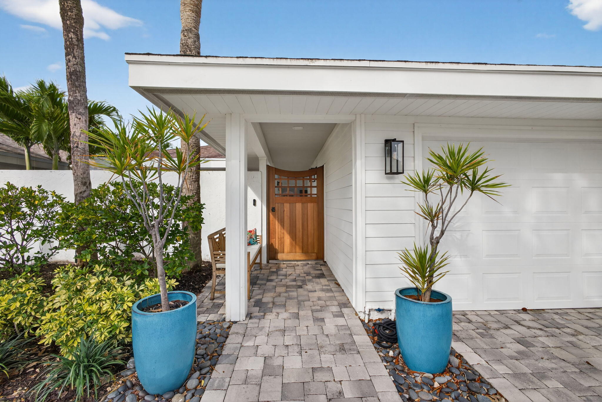 17085 Bay Street Jupiter, FL 33477 - Photo 38 of 44 a front view of a house with a potted plant