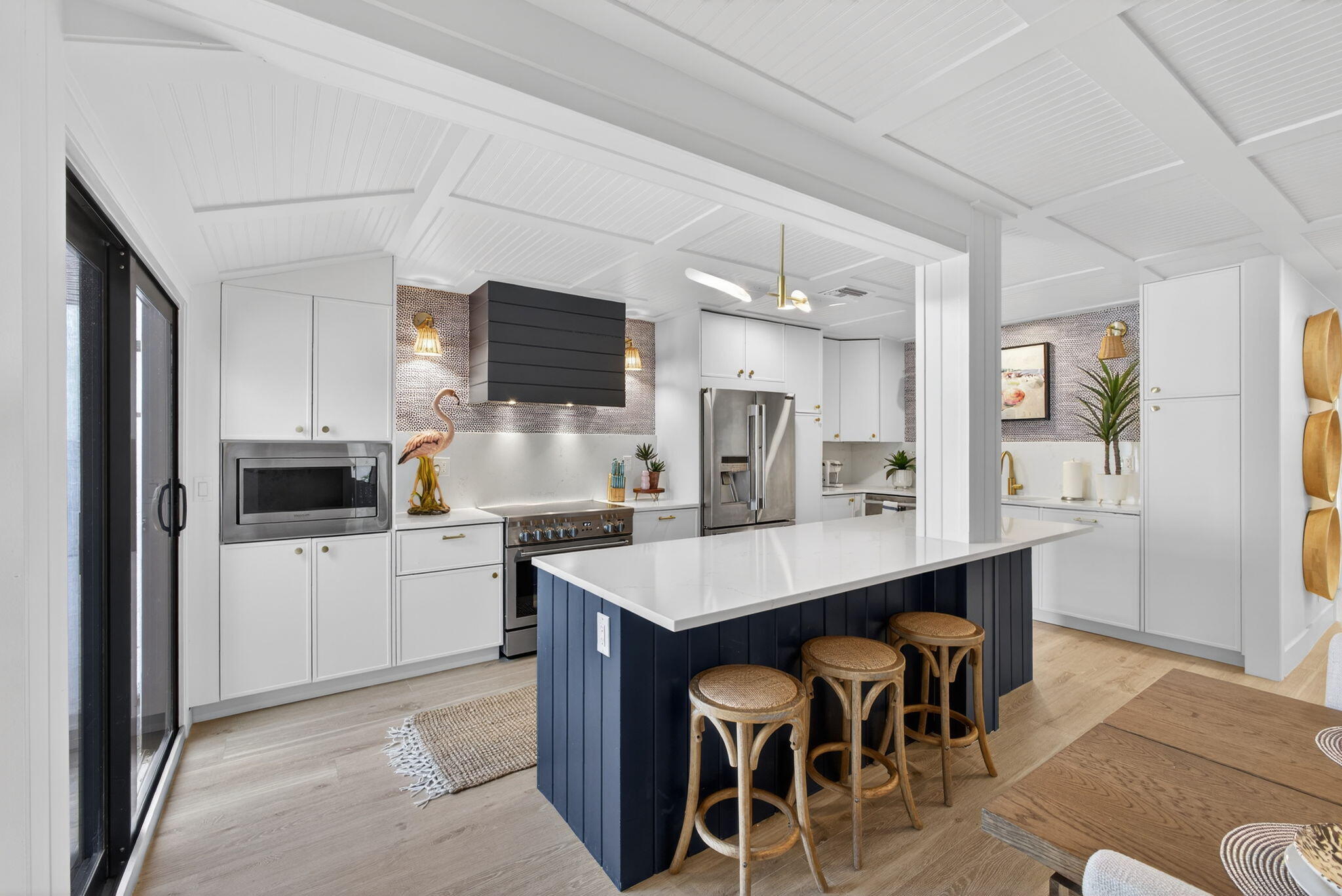 17085 Bay Street Jupiter, FL 33477 - Photo 4 of 44 a kitchen with a dining table chairs and refrigerator