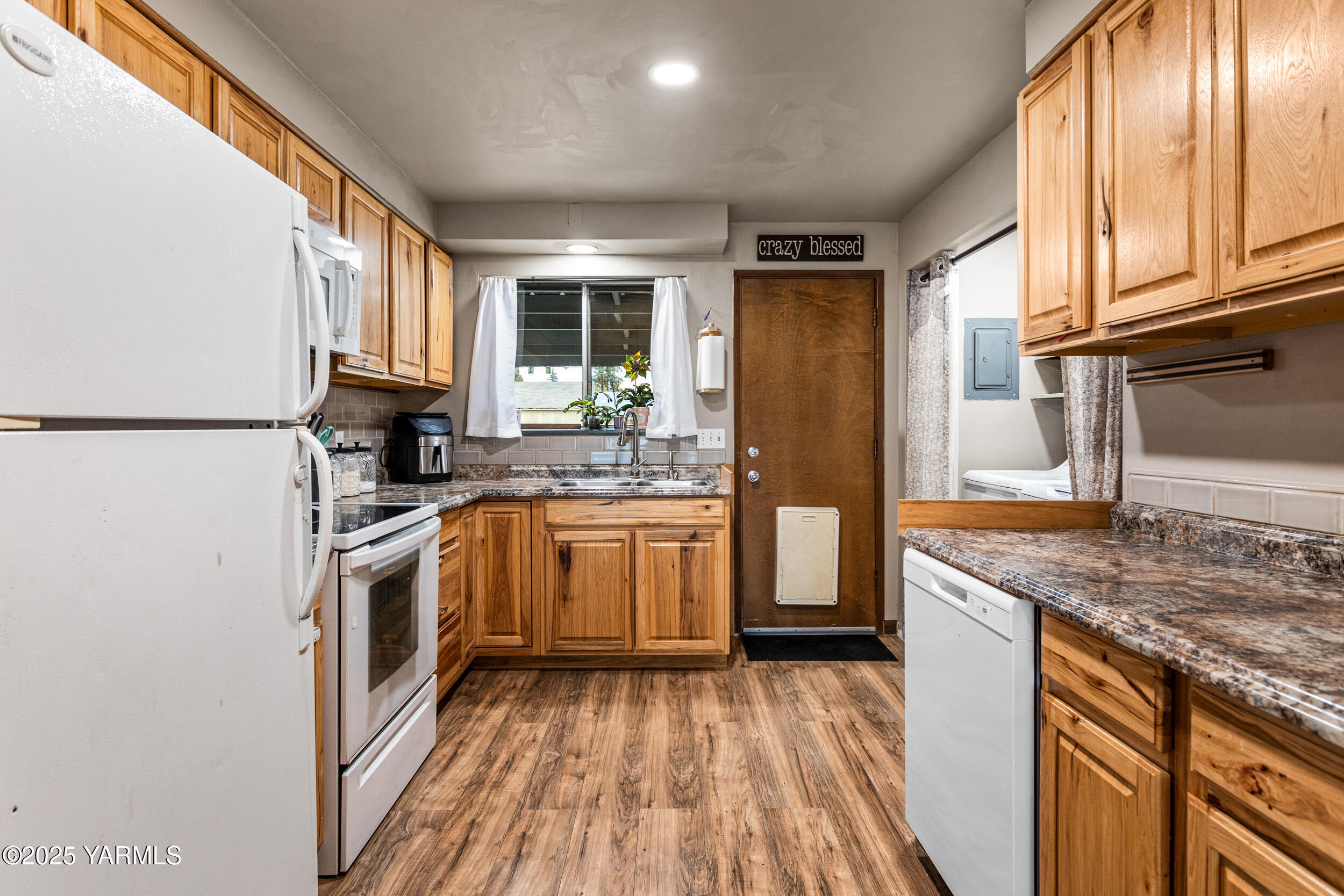 31 Link Road Naches, WA 98937 - Photo 11 of 35 a kitchen with a refrigerator a sink and wooden cabinets