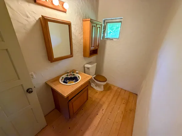 a view of a room with wooden floor