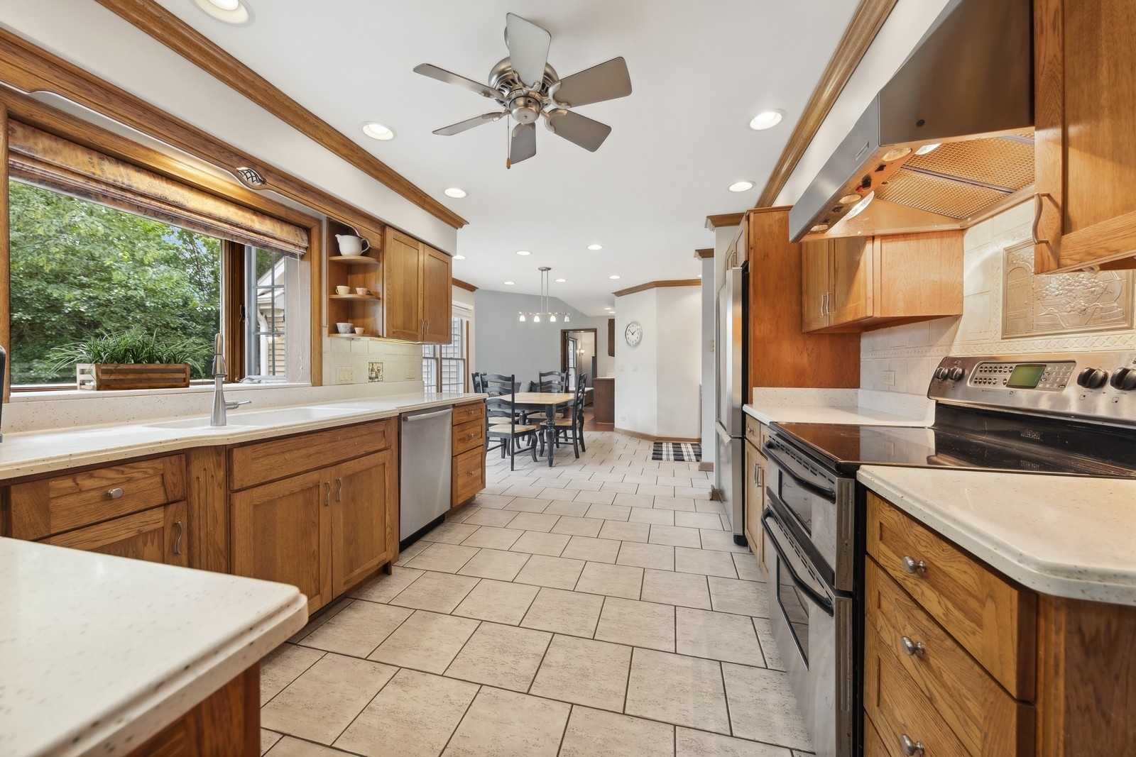 1531 Pinehurst Drive Darien, IL 60561 - Photo 16 of 38 a kitchen with stainless steel appliances granite countertop a sink counter space cabinets and a stove
