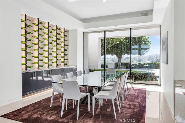 a dining room with furniture a floor to ceiling window and potted plants