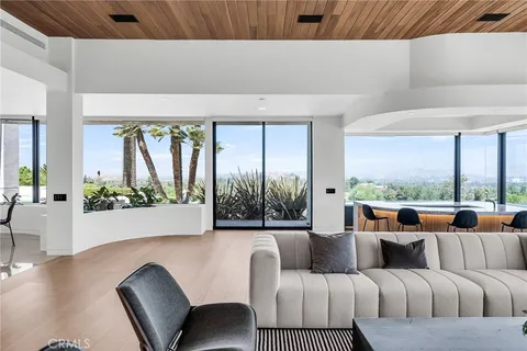 a living room with a couch and a potted plant
