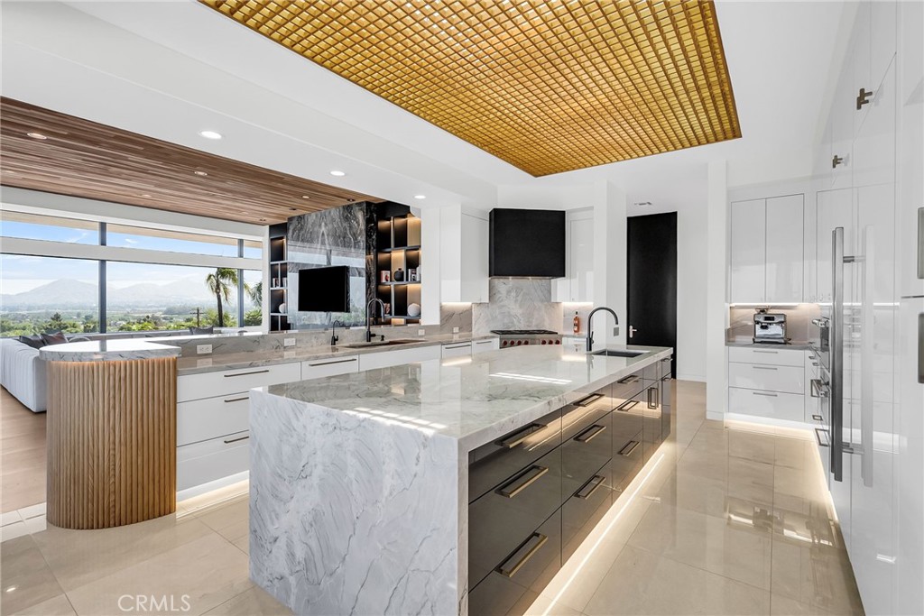 2130 Old Quarry Road Riverside, CA 92506 - Photo 35 of 75 a large kitchen with kitchen island a large counter top stainless steel appliances and cabinets
