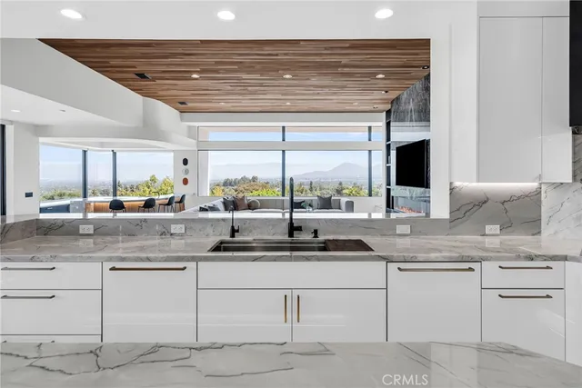 a spacious bedroom with a bed and chair