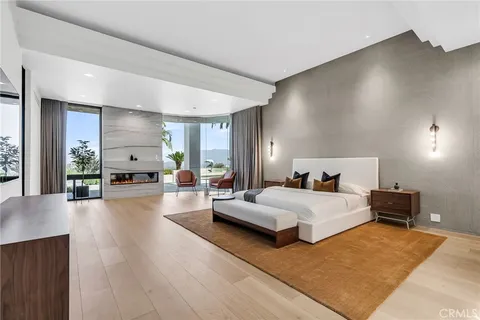 a bedroom with a bed and a large window