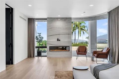 a bedroom with a bed and large window