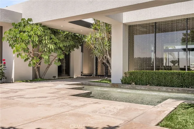 a view of a livingroom with a chandelier furniture and windows