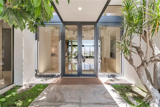 a living room with fireplace furniture and large windows