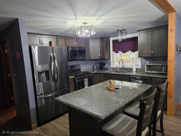 a kitchen with refrigerator and wooden floor