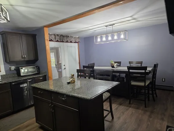 a kitchen with a sink cabinets and wooden floor