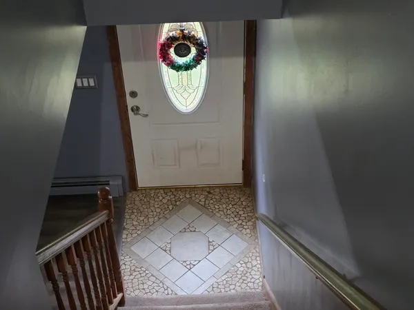 a bedroom with a bed lamp and a dresser