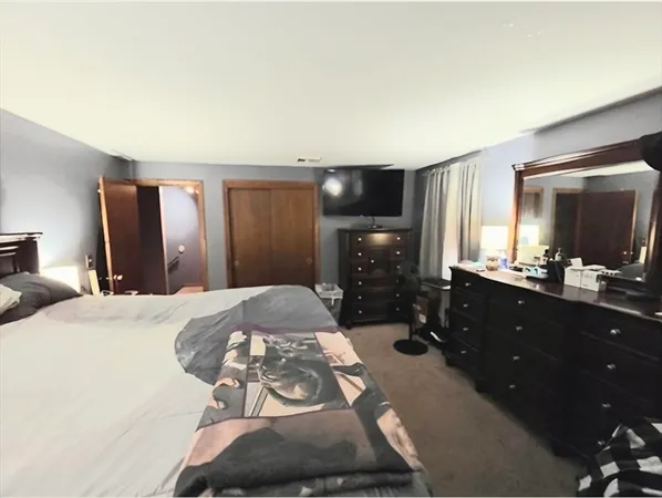 a bedroom with a bed and a lamp