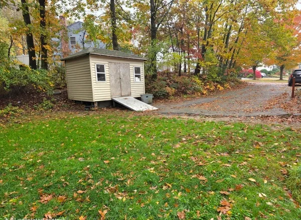 a view of a backyard with large trees