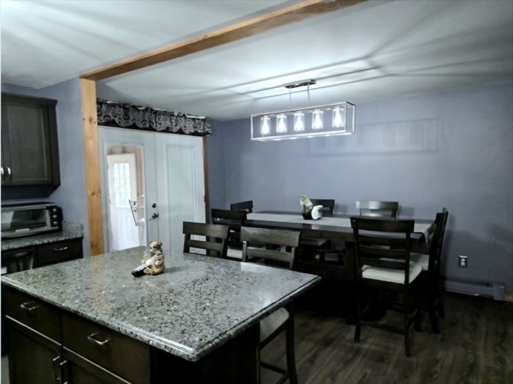 43 Emily Jeffers Road, Unit 43 Randolph, MA 02368 - Photo 9 of 31 a kitchen with a table chairs and wooden floor