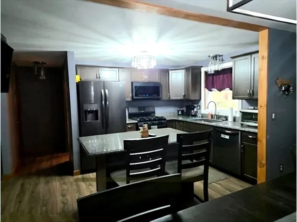 a kitchen with a refrigerator and a sink