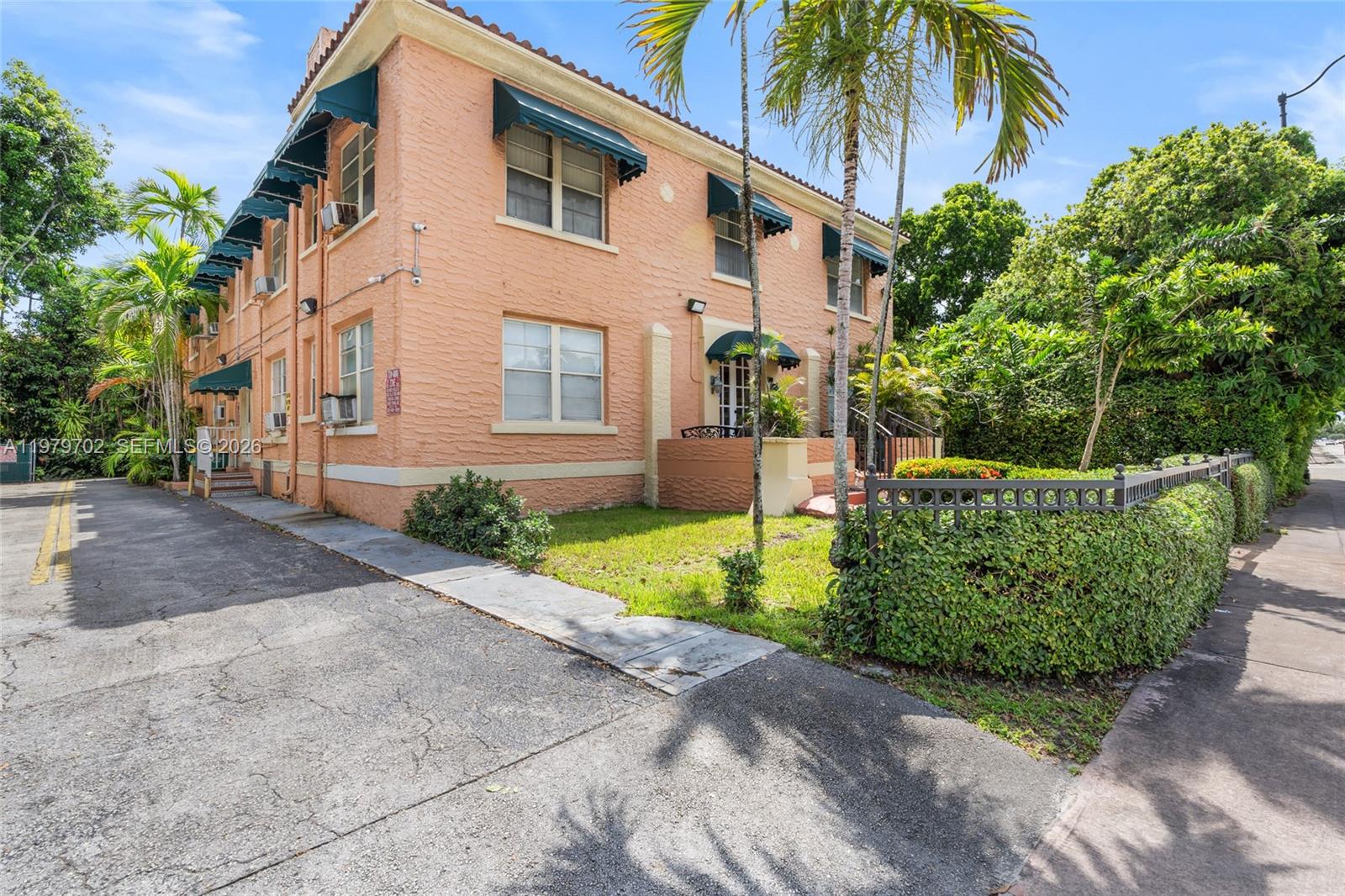 3409 South Le Jeune Road Coral Gables, FL 33134 - Photo 50 of 53 a front view of a house with a yard and potted plants