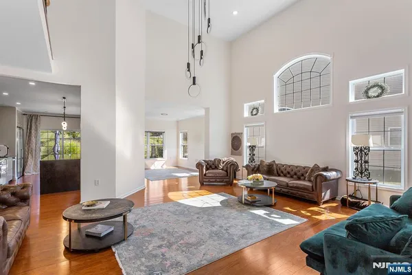 a living room with furniture and a chandelier