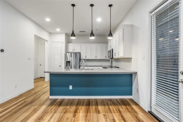 a view of kitchen with wooden floor