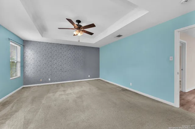 a view of a livingroom with a ceiling fan and window
