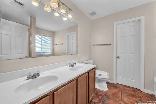 a white bath tub sitting in a bathroom next to a window