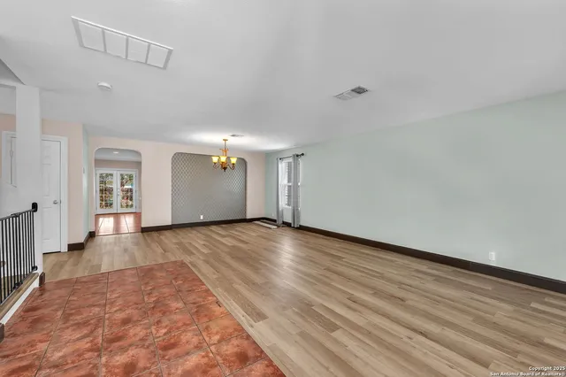 a view of a room with wooden floor and white walls