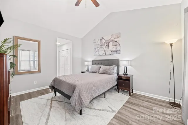 a bedroom with a bed and a painting on the wall
