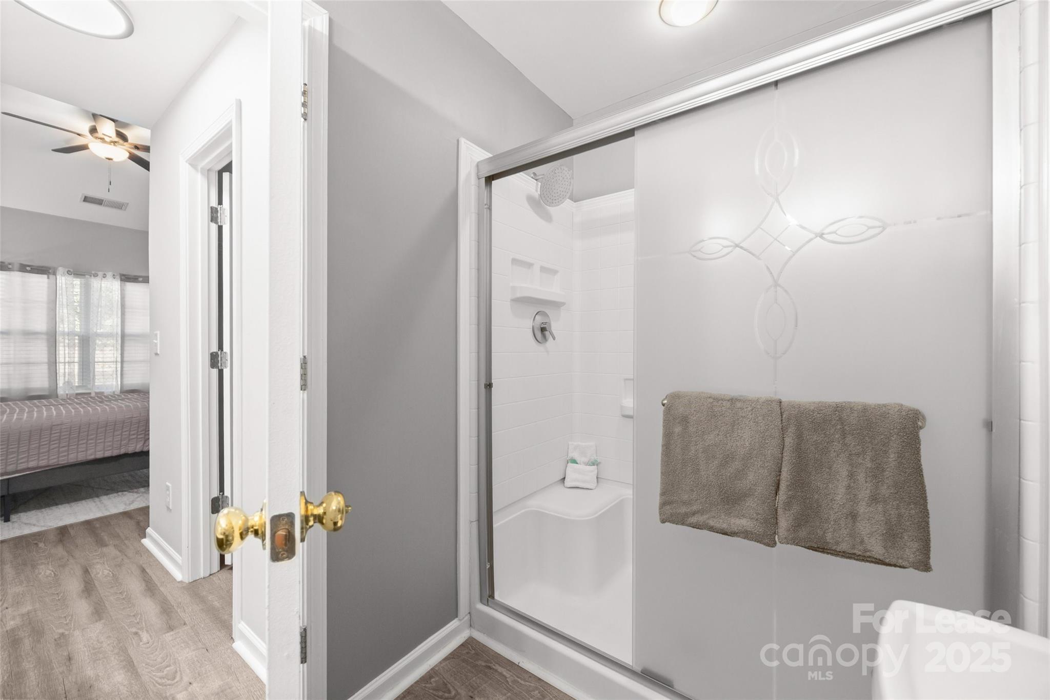 16865 Timber Crossing Road Charlotte, NC 28213 - Photo 17 of 39 a bathroom with a tub and shower