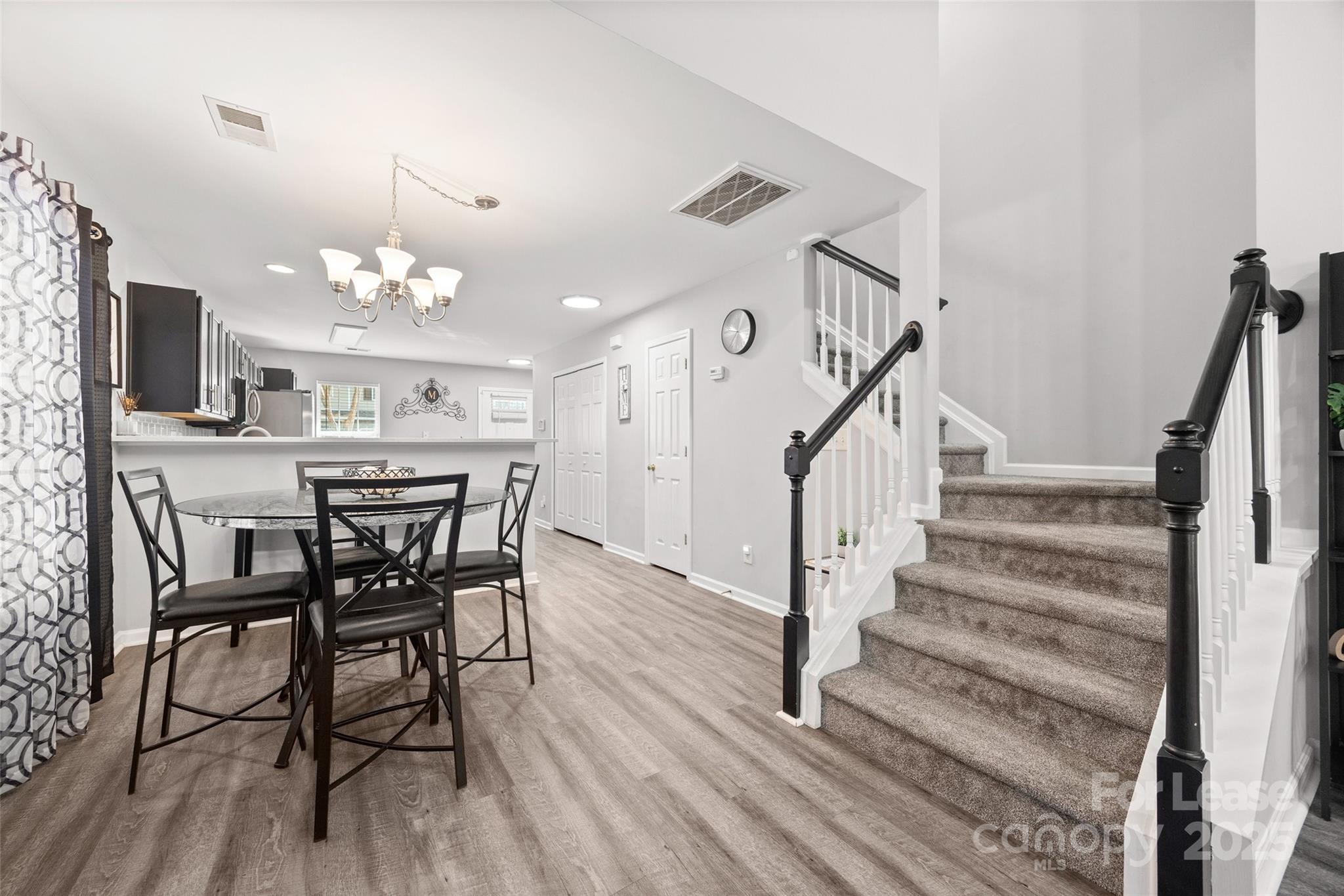 16865 Timber Crossing Road Charlotte, NC 28213 - Photo 18 of 39 a view of a dining room with furniture and wooden floor
