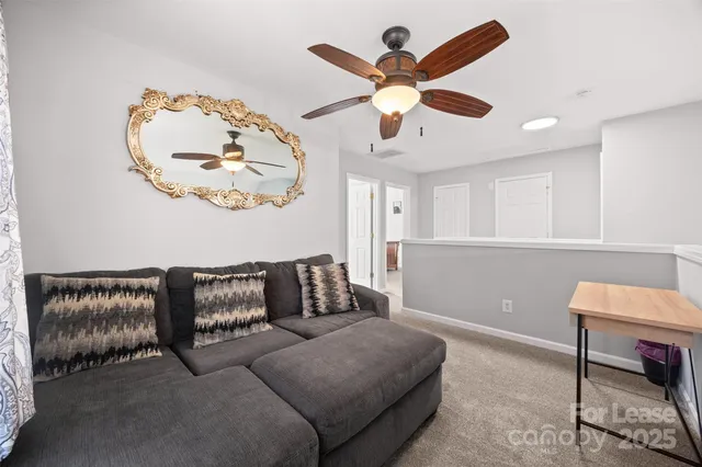 a bedroom with two beds and ceiling fan