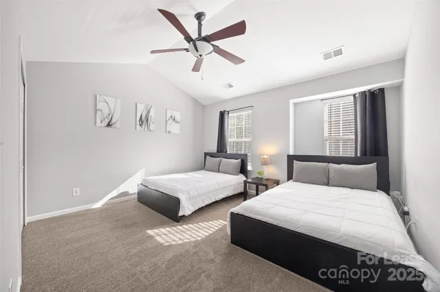 a bed room with a bed and a ceiling fan