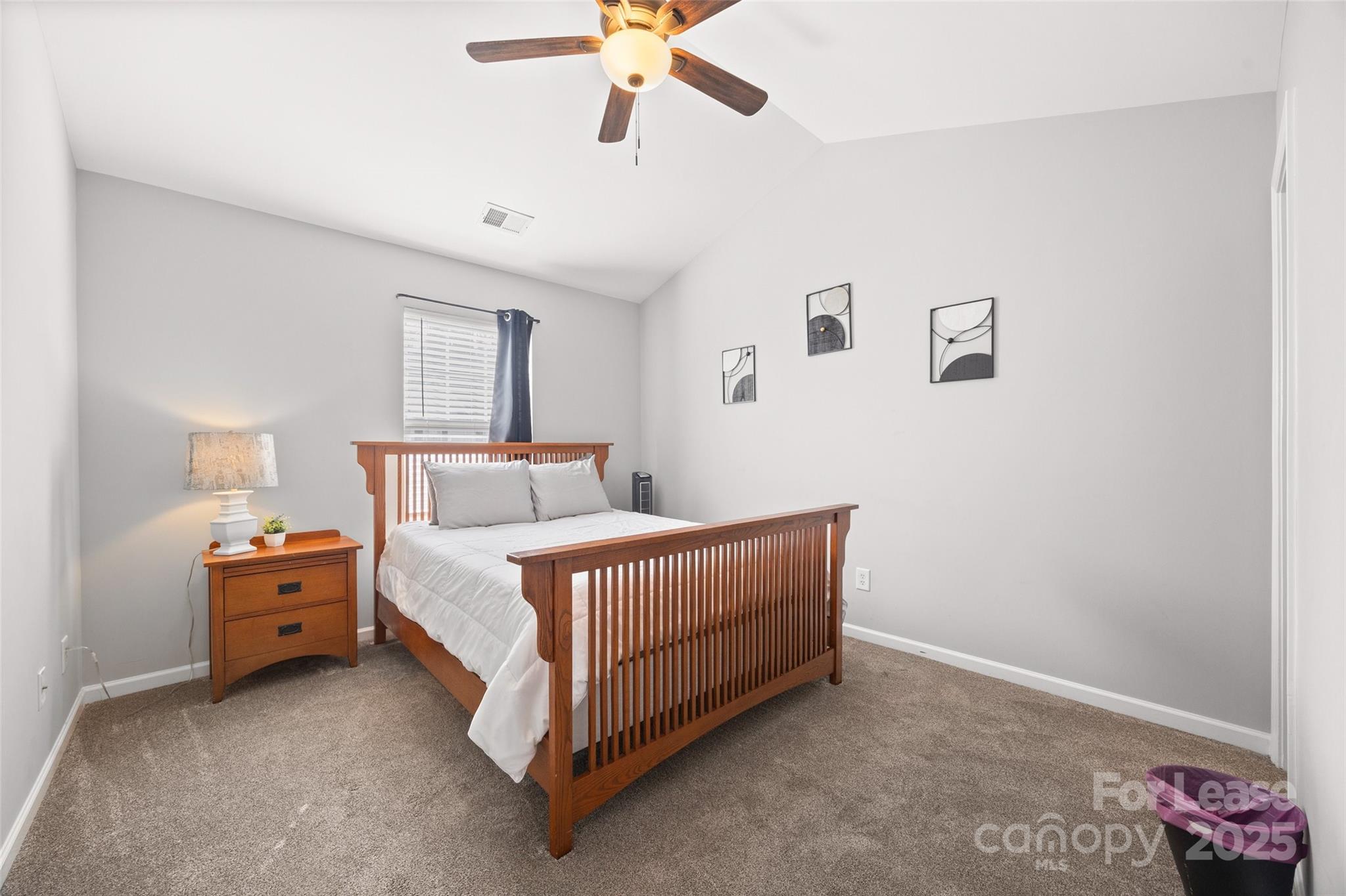 16865 Timber Crossing Road Charlotte, NC 28213 - Photo 22 of 39 a bed room with a bed and a ceiling fan